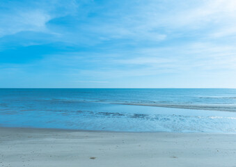 Fototapeta na wymiar Grey beach and blue sea