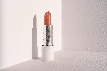 Moisturizing lipstick with water drops on it.