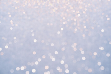 Fototapeta na wymiar Festive Blue background of silver glitter lights. Winter snowy blurred abstraction