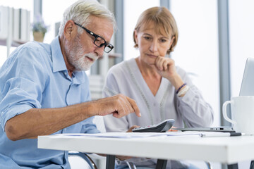 Obraz premium Stressed husband, wife senior couple elderly family, hand of caucasian mature, retired press calculator calculate budget from invoice, no money. Mortgage, loan causing debt, bankruptcy of financial.