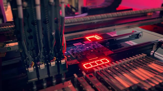 Automatic SMT Pick and Place machine picks elements up and then places them onto the motherboard. Motherboards and Computer Chips Production by Automatic SMT Pick and Place machine.