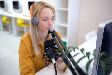 young woman is streaming while sitting in coworking at the computer