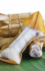 traditional indonesian dessert called Lepet made from sticky rice and read bean covered with coconut leaf