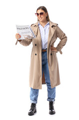 Young woman in coat reading newspaper on white background