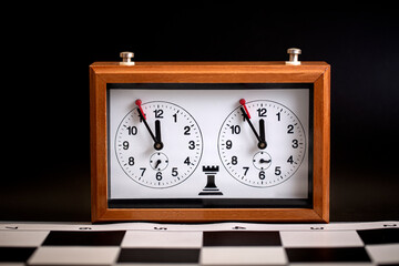 classic, mechanical chess clock on wooden chess board. Selective focus