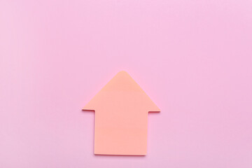 Obraz na płótnie Canvas Sticky notes in shape of arrow on pink background