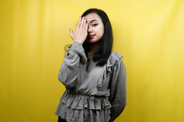 Beautiful young woman with hand closed one eye isolated