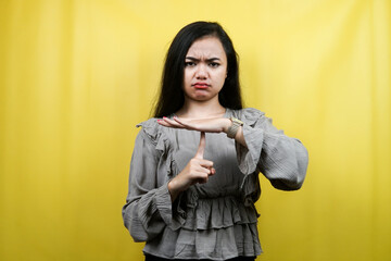 Beautiful young woman seriously, with hands stop talking, don't make noise, please be quiet, isolated