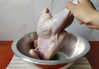 Preparing Raw Whole Chicken for Stuffing and Roasting
