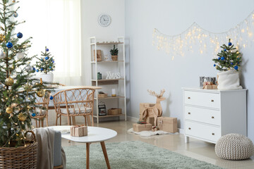 Interior of light dining room with beautiful Christmas trees