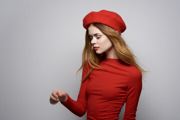 beautiful woman with a red cap on his head glamor studio posing