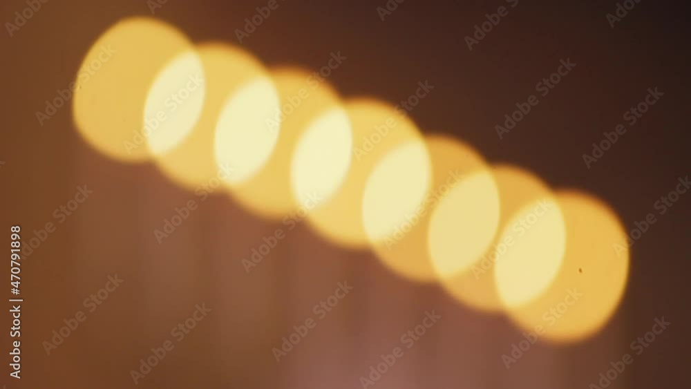 Poster group of candles out of focus creating a dramatic bokeh image.