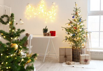 Beautiful Christmas tree with gifts in interior of light room