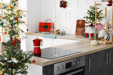 Coffee maker on stove in modern kitchen decorated for Christmas
