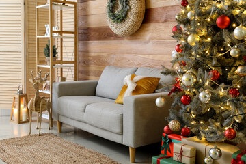 Interior of stylish living room with grey sofa and big Christmas tree