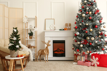 Interior of light living room with fireplace, Christmas tree and folding screen