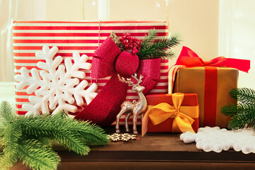 Fototapeta na wymiar Gift boxes with Christmas decor on mantelpiece near window