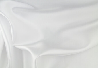 White satin or silk fabric as background. Elegant wallpaper, wedding backdrop or design element.	