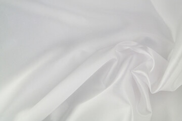 Obraz premium White satin or silk fabric as background. Elegant wallpaper, wedding backdrop or design element. 