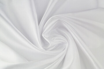 White satin or silk fabric as background. Elegant wallpaper, wedding backdrop or design element.	