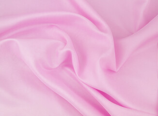 Pink satin or silk fabric background.	