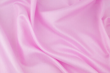 Pink satin or silk fabric background.	