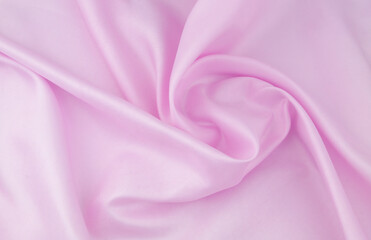 Pink satin or silk fabric background.	