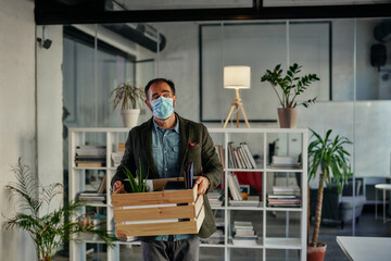 Businessman with face mask coming back to work