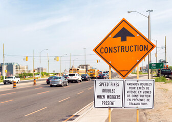 A construction sign by an urban road