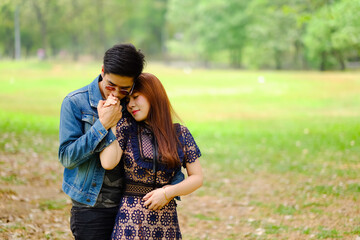 Fototapeta premium Portrait asia young couple in love, boyfriend and girlfriend happy in park