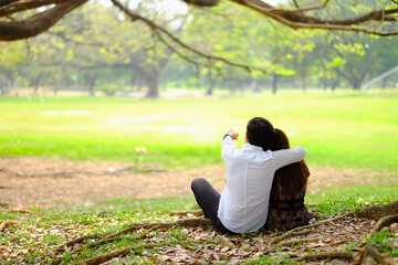 Portrait asia young couple in love, boyfriend and girlfriend happy in park