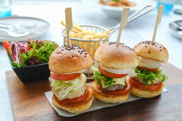 mini three burgers served with french fries