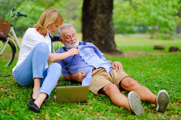 Fototapeta premium senior woman take care old man That is tired from exercise in park