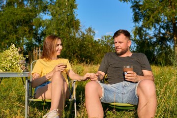 Happy middle-aged married couple having rest outdoors, in nature