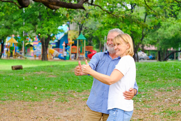 caucasian senior woman and old man, couple elder in love happy in park