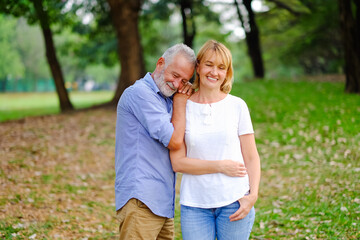 caucasian senior woman and old man, couple elder in love happy in park