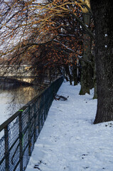 Winter promenade walk at riverbank of River Isar in Munich Muenchen, Germany on ice cold day with...