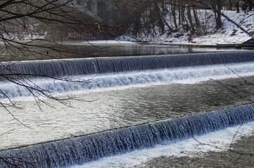 Winter promenade walk at riverbank of River Isar in Munich Muenchen, Germany on ice cold day with...