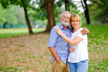 caucasian senior woman and old man, couple elder in love happy in park