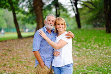 caucasian senior woman and old man, couple elder in love happy in park