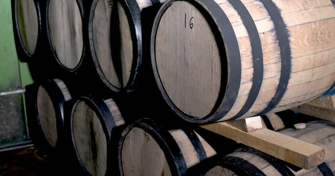 Stacked barrels filled with tequila for maturation tequila industry concept