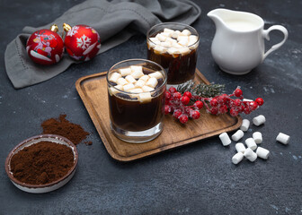 coffee with marshmallows for two on a dark table with Christmas decorations 