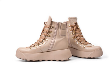 Womens beige leather boots with zip and lacing, photographed against a white background.