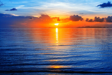 Colorful sea sunset view, bright ocean sunrise, yellow golden sun glow reflection, blue water waves, red orange sky, cloud, beautiful tropical island coast landscape, summer holidays, vacation, travel