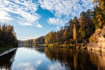pedestrian bridge over the river Gauja near the devil cliff on a autumn day, Krimulda, Latvia