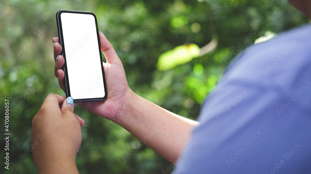 Poster close up view female holding mock up mobile phone with blank screen..