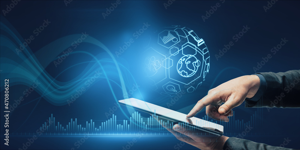 Poster close up of businessman hand pointing at tablet with creative spherical business interface on blue b