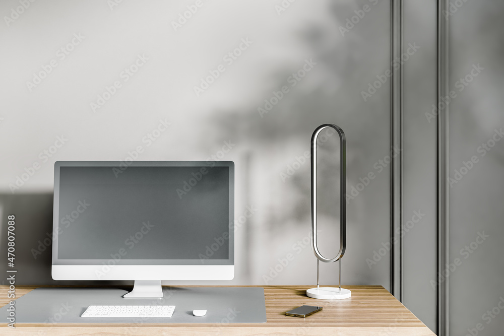 Poster Close up of creative designer desktop with empty black computer screen, keyboard and other items on concrete wall background. Workplace concept. Mock up, 3D Rendering.