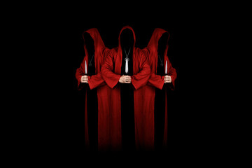 Mystery people in a red hooded cloaks in the dark holding ritual daggers. Hiding face in shadow. ...