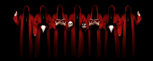 Mystery people in a red hooded cloaks in the dark. Hiding face in shadow. Pointing up with fingers. Satanic symbols. Dark ritual. Sectarians. Isolated on black.